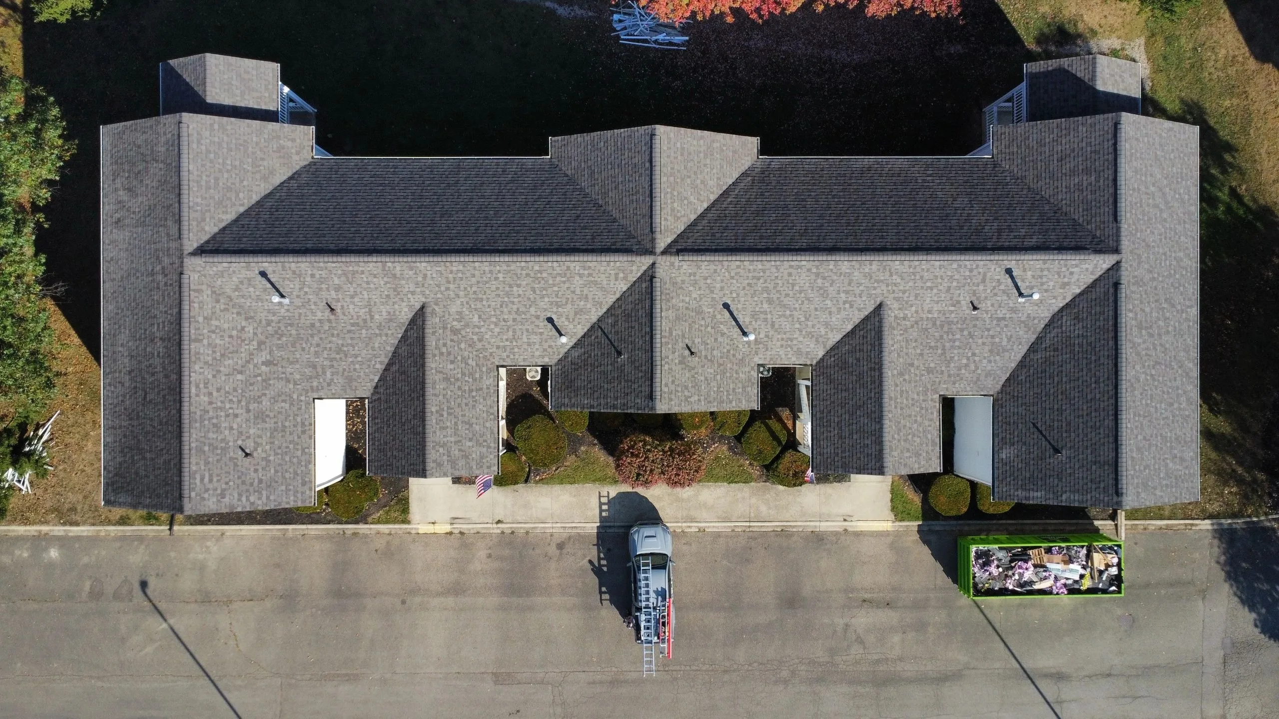 Aerial view of a completed grey roof across a multi-section home