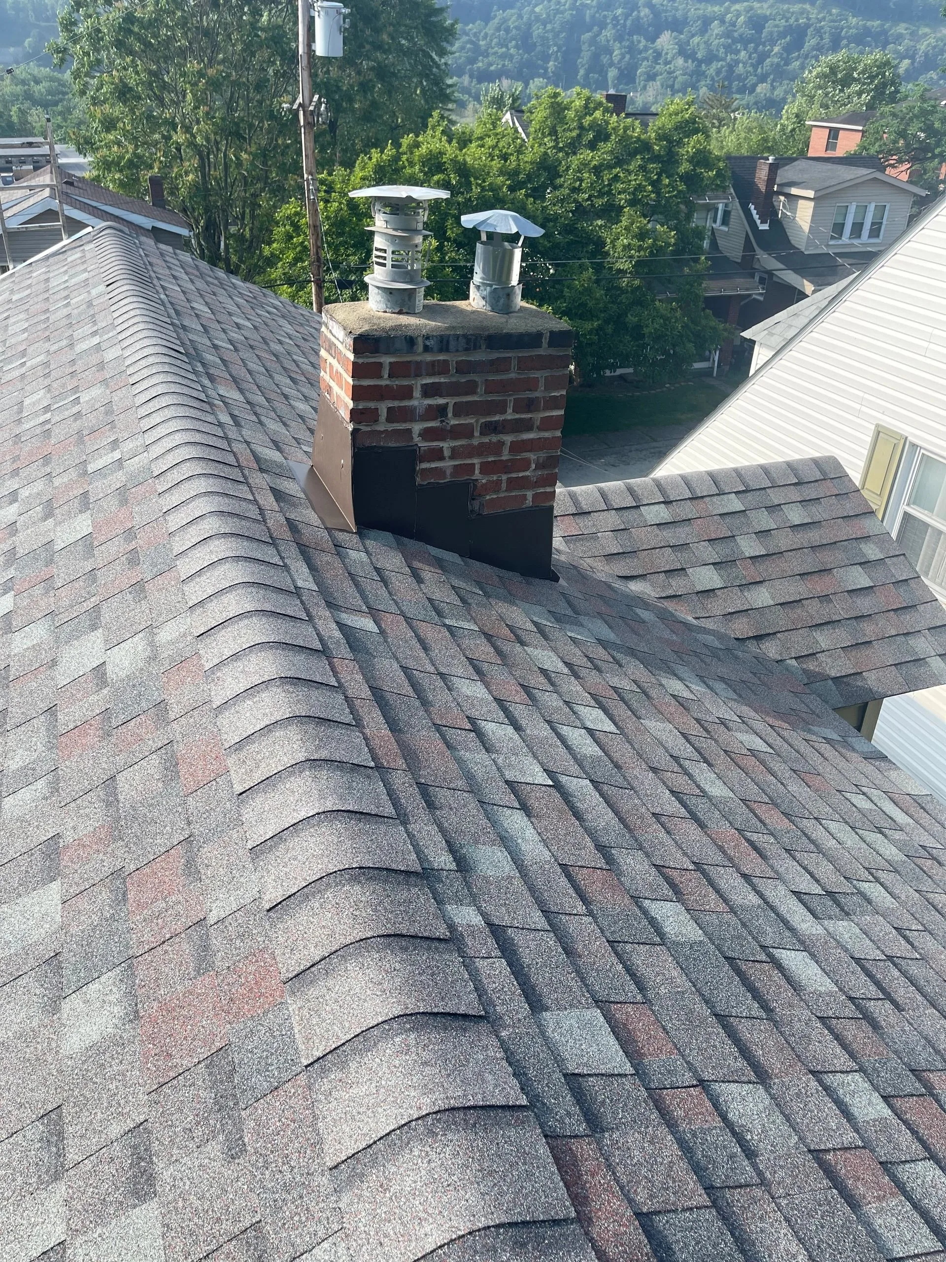 Finished roof with a brick chimney and two ventilation stacks