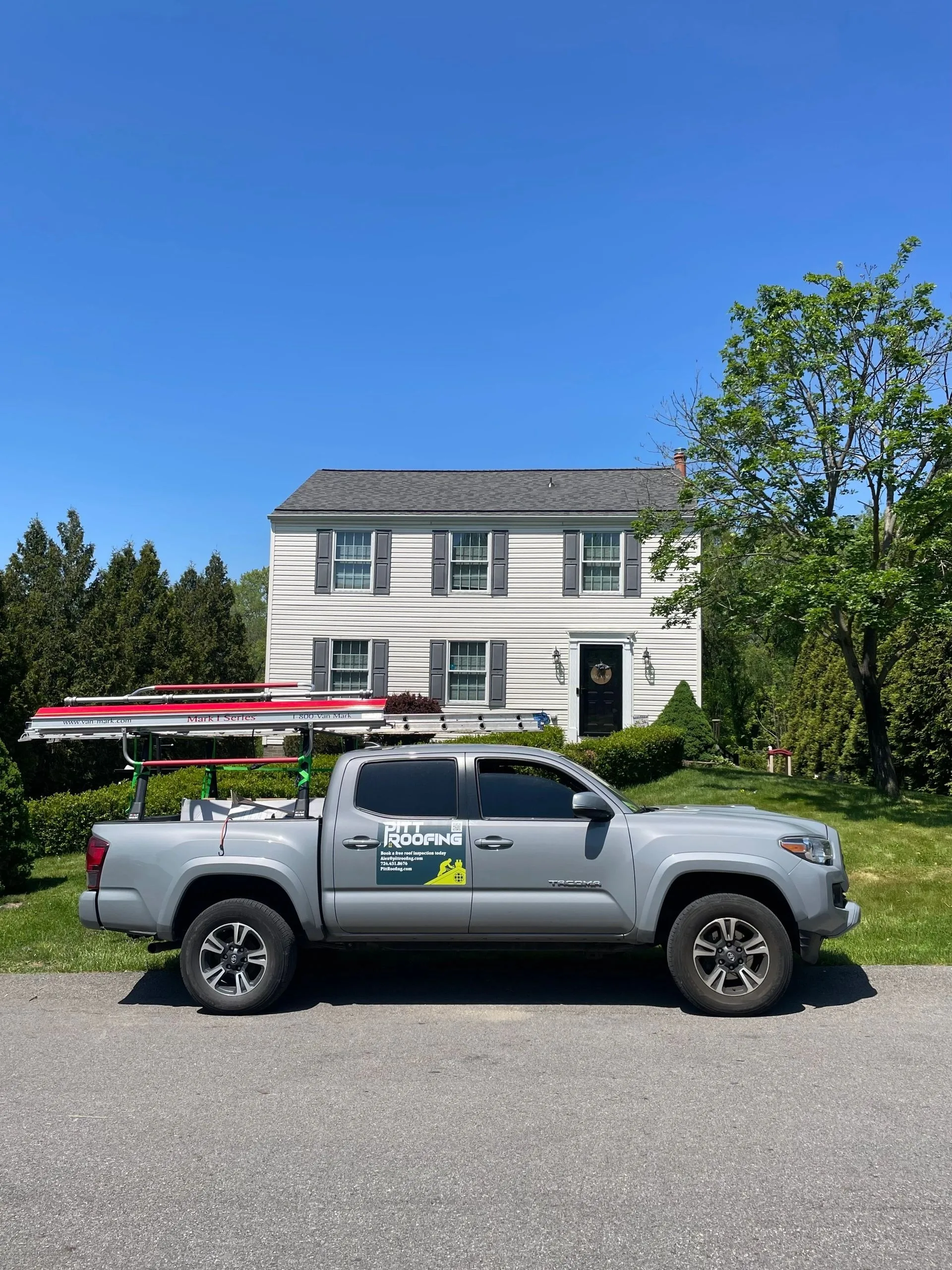 Pitt Roofing truck parked at a finished job on a residential street